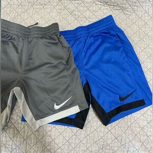 2 pairs of Nike athletic shorts for boys sized Small.